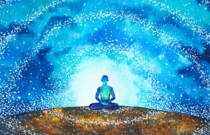 宇宙と大地と座る人のシルエット