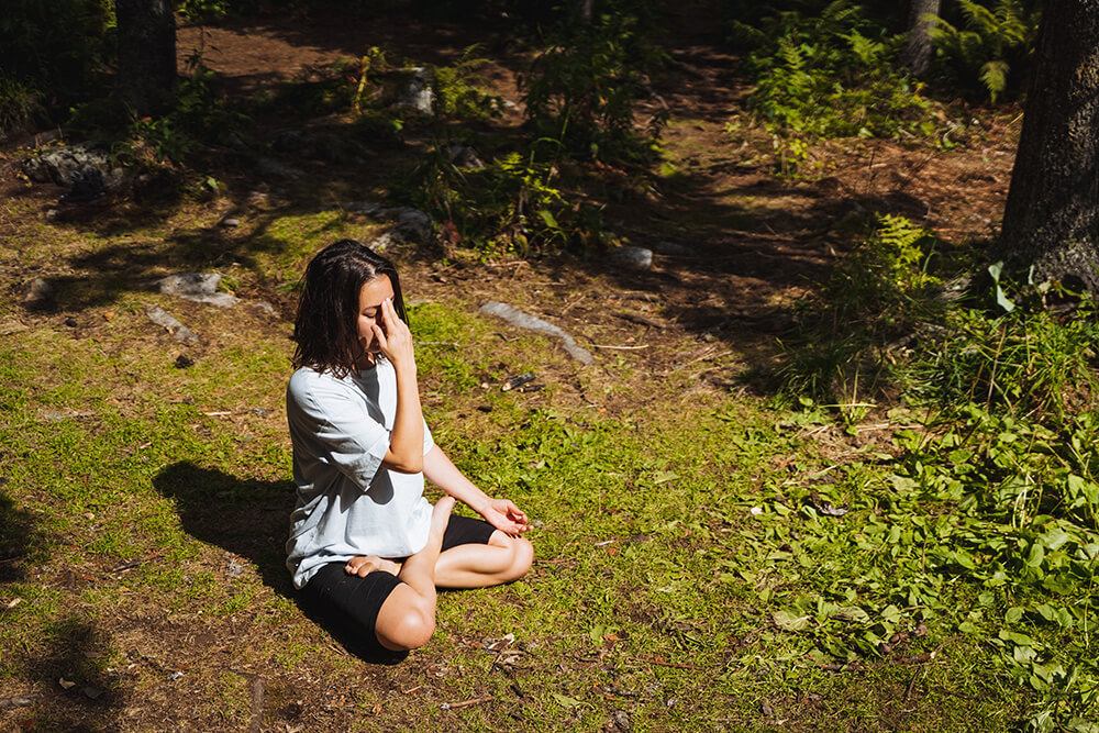 自然の中で瞑想をする女性
